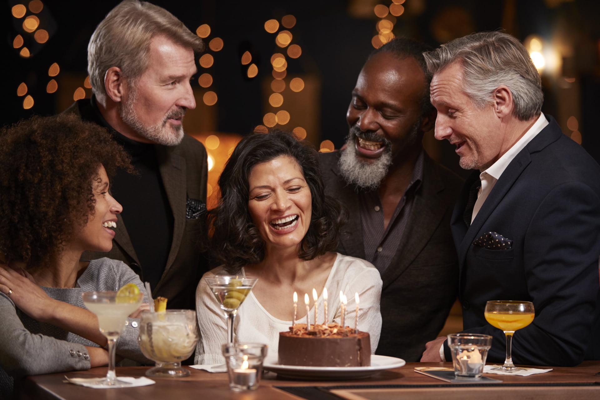 Group Of Middle Aged Friends Celebrating Birthday In Bar