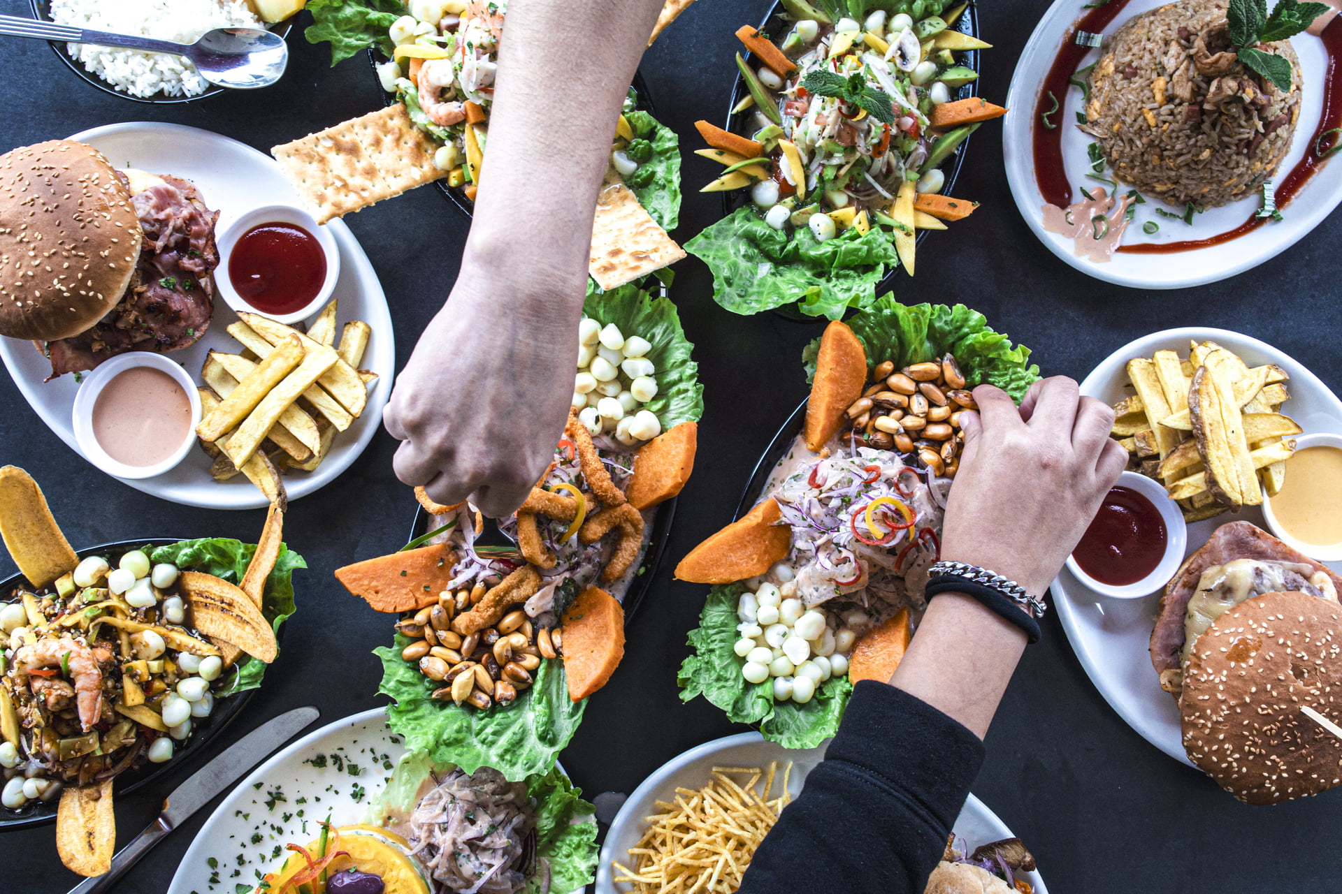 Overhead view of a group of people celebrating and eating in a Peruvian restaurant